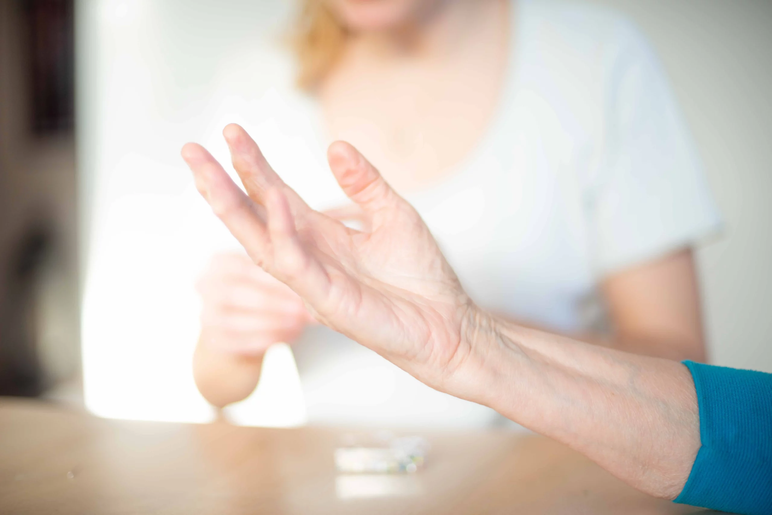 Patient streckt bei der Handtherapie die Finger